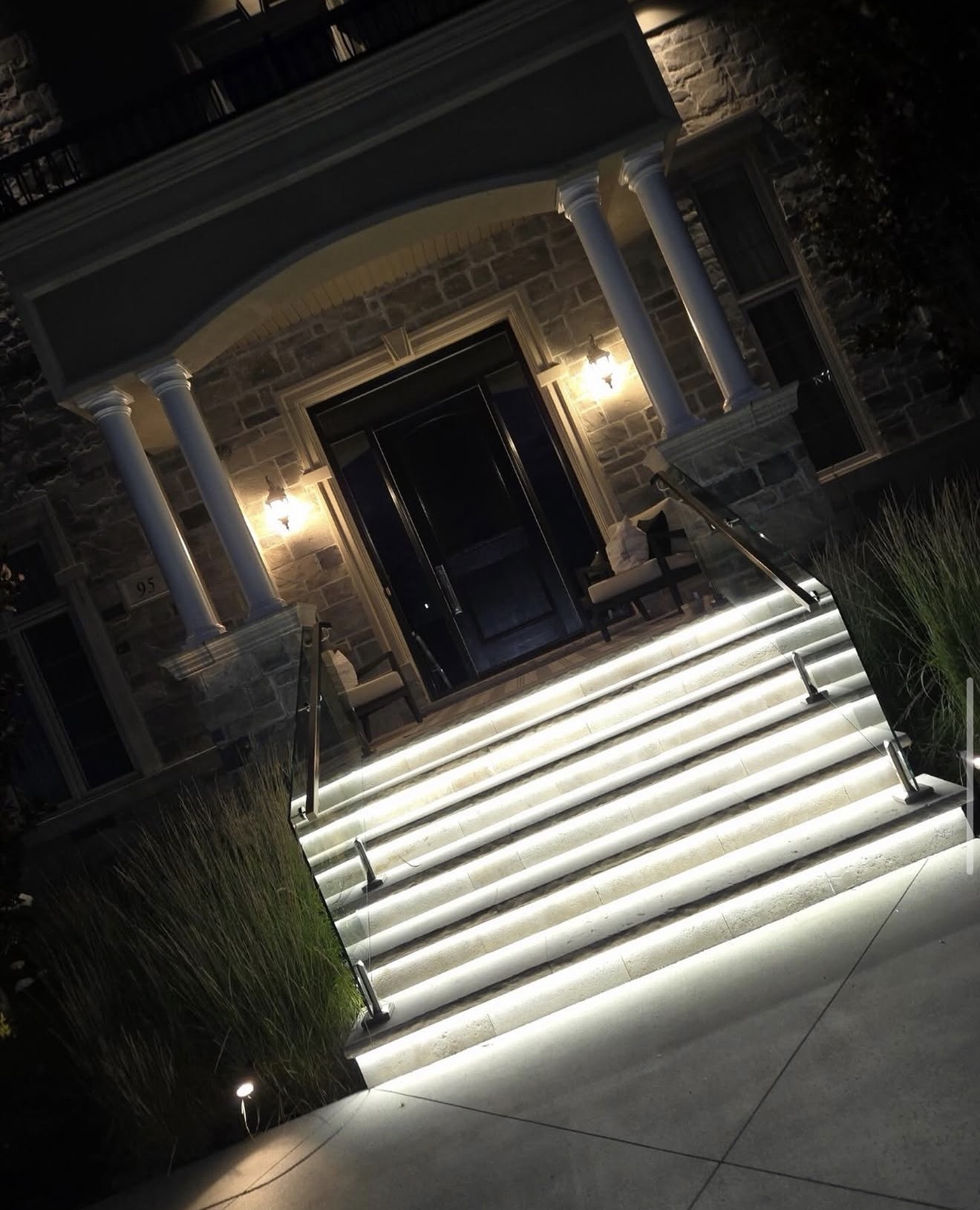 Grand front entrance with glowing LED stair lighting