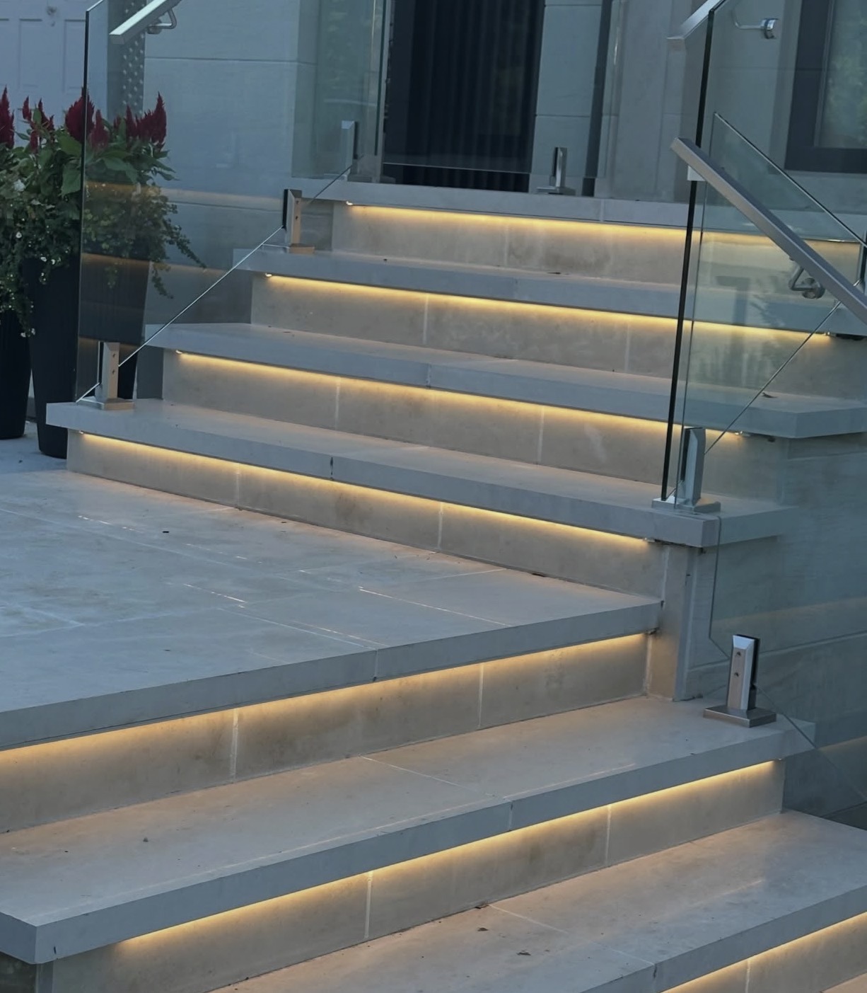 Modern stone stairs with warm LED strip step lighting